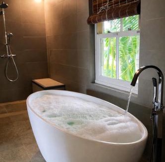 Cap Malheureux Apartment | Cinnamon Room Four-Poster Bed, Freestanding Bath, Walk-In Shower & Infinity Pool