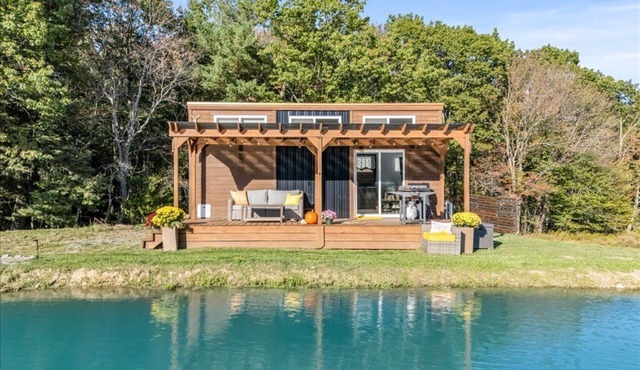 Waterfront Tiny House Perched on the Pond Covered Deck at Water’s Edge in Brackney